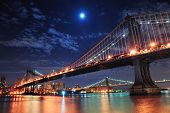 foto of reflection  - Brooklyn Bridge and Manhattan Bridge over East River at night with moon in New York City Manhattan with lights and reflections - JPG 