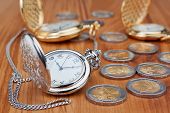 stock photo of watch  - Group pocket watch against the background of euro coins - JPG 