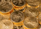 picture of currency  - Stacks of gold eagle one troy ounce golden coins from US Treasury mint - JPG 