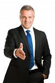 picture of handshake  - Friendly mature man giving hand for an handshake to seal the agreement isolated on white background - JPG 
