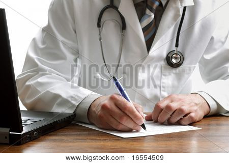 Picture or Photo of Doctor writing patient notes on a medical examination or prescription