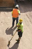 pic of construction worker  - foreman on cellphone with plans  - JPG 