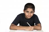 stock photo of future  - An handsome Indian kid doing his homework diligently - JPG 