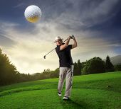 stock photo of golf  - Portrait of a man playing golf on a field - JPG 