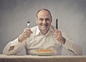 stock photo of close-up  - Smiling fat man in front of a plate of spaghetti - JPG 