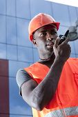 stock photo of construction worker  - Construction worker speaking on Walkie - JPG 