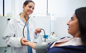 picture of pressure  - Doctor checking female patients blood pressure in hospital room - JPG 