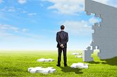 pic of puzzle  - Businessman with a puzzle pieces on the background - JPG 
