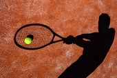 picture of competition  - shadow of a tennis player in action on a tennis court  - JPG 