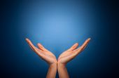 stock photo of blue  - Hands holding on blue background - JPG 