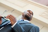 pic of business people  - An African American business man wearing his sunglasses and business suit in the city - JPG 