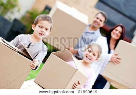 Picture or Photo of Family moving home and carrying cardboard boxes