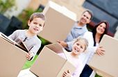 stock photo of home  - Family moving home and carrying cardboard boxes - JPG 