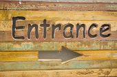 stock photo of entrance  - Wooden sign at the entrance to the letters and arrows - JPG 