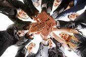 stock photo of teamwork  - business people teamwork in an office with hands together  - JPG 