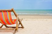 picture of beach  - An empty wooden beach chair at the beach - JPG 
