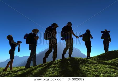Picture or Photo of Silhouette of a group of people on the grass.
