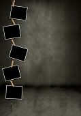 stock photo of  photo  - Blank photos hanging vertically in a dark grungy room - JPG 