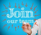 stock photo of team  - Smiling designer using his tablet pc while team works behind - JPG 