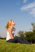 stock photo of blue sky  - Young pretty woman in the park - JPG 