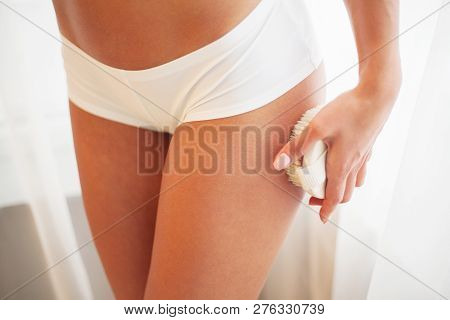 Poster: Womans Arm Holding Dry Brush