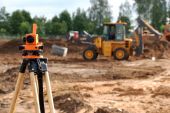 stock photo of survey  - Using theodolite at construction site for land level measurement - JPG 