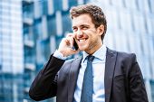 pic of businessmen  - Portrait of a young businessman talking on the phone - JPG 