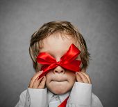 image of boy  - little boy with a red bow in hand - JPG 