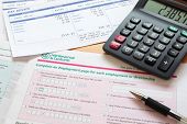 pic of revenue  - Photo of a UK self assessment tax return with calculator and payslips - JPG 