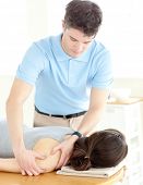 foto of pressure  - Handsome physical therapist giving a back massage in a health center - JPG 