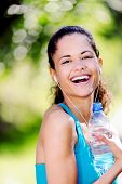 foto of fitness  - Portrait of a runner listening to music on headphones and holding water bottle - JPG 