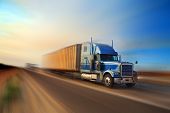picture of transportation  - American truck speeding on freeway at sunset - JPG 