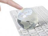 foto of globe  - Globe on keyboard isolated on white - JPG 