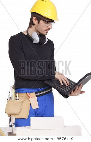 Picture or Photo of Construction worker working with laptop on white background