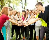 stock photo of people  - large group of young people with their hands together outdoor - JPG 