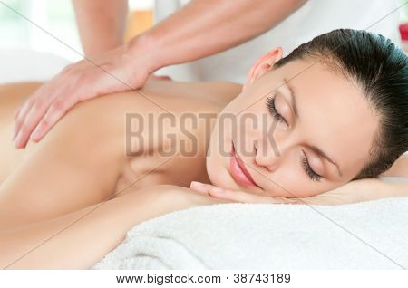 Picture or Photo of Beautiful young woman relaxing with hand massage at beauty spa