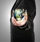 pic of globe  - Business man holding the small world in his hands against white background  - JPG 