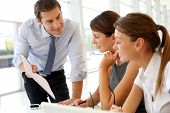 foto of employee  - Manager presenting business plan to employees - JPG 