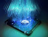stock photo of byte  - harddisk and heads on technology fiber optics background - JPG 