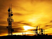 pic of sunset  - Several radio towers with sunset sky in background - JPG 