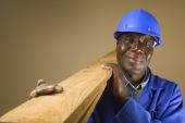 picture of construction worker  - Senior South African or American plumber carpenter or builder with wooden planks - JPG 