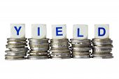 stock photo of yield  - Stacks of coins with the word YIELD isolated on white background - JPG 