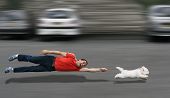 foto of dog  - Disobedient dog running and dragging a man by the leash
 - JPG 