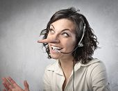 stock photo of receptionist  - Smiling insincere receptionist with long nose talking on the telephone - JPG 