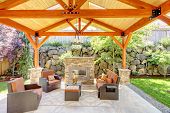 stock photo of property  - Exterior covered patio with fireplace and furniture - JPG 