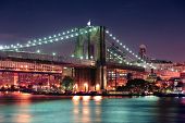 stock photo of bridge  - Brooklyn Bridge over East River at night in New York City Manhattan with lights and reflections - JPG 