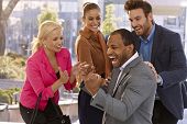 image of businessmen  - Happy afro businessman and colleagues celebrating success - JPG 