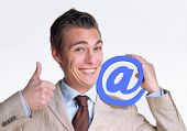 foto of businessmen  - Optimistic young businessman holding an email symbol - JPG 