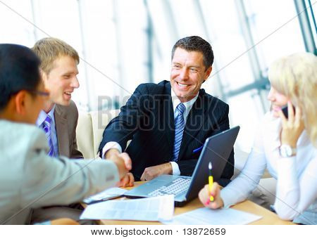Picture or Photo of Business people shaking hands, finishing up a meeting