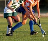 picture of woman  - Two women battle for control of ball during field hockey game - JPG 